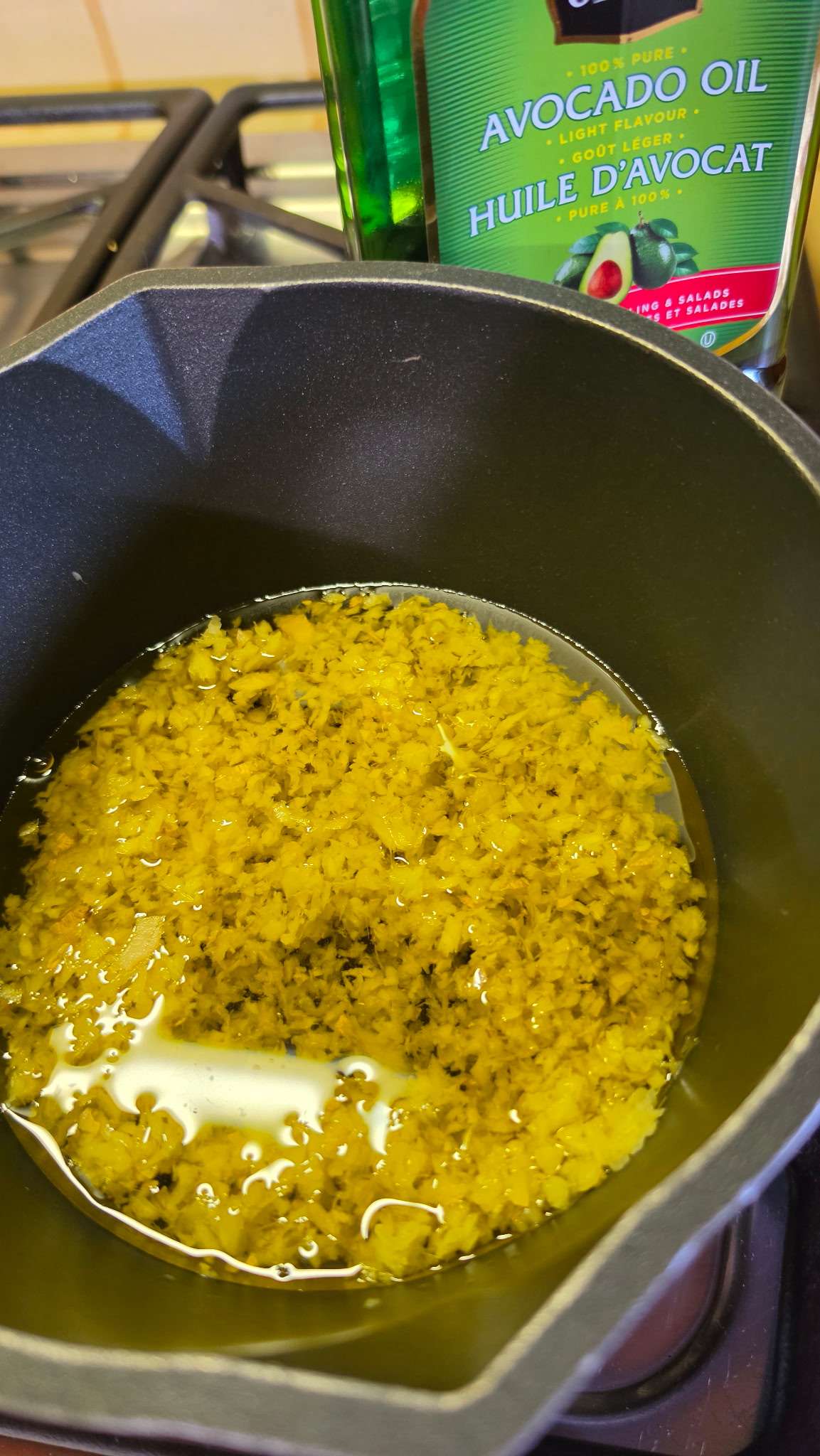 Minced ginger combined with avocado oil in a pot Minced ginger combined with avocado oil in a pot